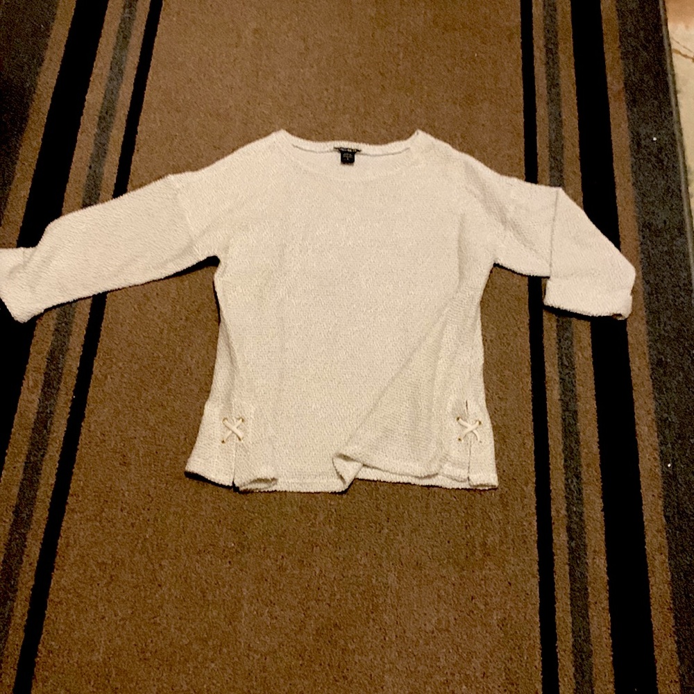 Women’s hip length top, good with leggings, detail on each side. New with tags
